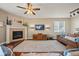 Inviting living room features a cozy fireplace, ceiling fan, and stylish hardwood floors at 7967 E 139Th Pl, Thornton, CO 80602