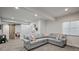 Spacious living room with a large sectional sofa, a deer head decoration, and a sliding barn door at 7967 E 139Th Pl, Thornton, CO 80602