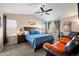 Spacious primary bedroom with a vaulted ceiling, a ceiling fan, and a cozy sitting area at 7967 E 139Th Pl, Thornton, CO 80602