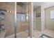 Modern bathroom showcases a glass-enclosed shower with a rainfall showerhead and tiled walls at 7967 E 139Th Pl, Thornton, CO 80602