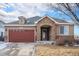 Ranch style home with stone accents and a two-car garage at 6321 Spring Gulch St, Frederick, CO 80516