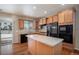 Kitchen boasts an island and stainless steel appliances at 6321 Spring Gulch St, Frederick, CO 80516