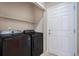 Laundry room with washer, dryer, and shelving at 6321 Spring Gulch St, Frederick, CO 80516