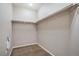 Large walk-in closet with double hanging rods and neutral walls at 6321 Spring Gulch St, Frederick, CO 80516