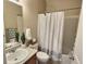 Well-lit bathroom featuring a shower-tub combo and a decorative plant on the vanity at 6321 Spring Gulch St, Frederick, CO 80516