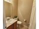 Compact half-bathroom with a sink and vanity, toilet, and neutral wall color at 6321 Spring Gulch St, Frederick, CO 80516