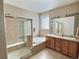 Primary bathroom with a separate shower and bathtub, featuring dual sinks and modern finishes for a spa-like experience at 6321 Spring Gulch St, Frederick, CO 80516