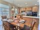 Bright dining area adjacent to kitchen, showcasing hardwood floors and ample natural light for enjoyable meals at 6321 Spring Gulch St, Frederick, CO 80516