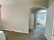 Hallway view leading into a carpeted room with an armchair and a window at 6321 Spring Gulch St, Frederick, CO 80516