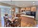Well-lit kitchen and dining area, featuring stainless steel appliances and a seamless connection to outdoor spaces at 6321 Spring Gulch St, Frederick, CO 80516