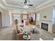 Inviting living room with a fireplace and open layout to the kitchen, creating a warm and connected living space at 6321 Spring Gulch St, Frederick, CO 80516