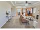 Open floor plan with living room flowing into kitchen and dining area, featuring modern finishes and ample natural light at 6321 Spring Gulch St, Frederick, CO 80516