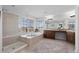 Luxurious bathroom featuring a glass shower, soaking tub, dual sinks, and natural light from the windows at 5322 Devils Head Cir, Golden, CO 80403