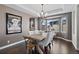 Bright dining room with dark floors, neutral walls, light wood table and a bay window with mountain views at 5322 Devils Head Cir, Golden, CO 80403