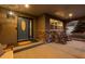 Inviting front porch with stone accents, rocking chairs, and a decorative front door with glass detail at 5322 Devils Head Cir, Golden, CO 80403