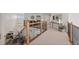 Open hallway with wood and wrought iron railing, plush carpet, and views to a living room at 5322 Devils Head Cir, Golden, CO 80403