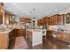 Gourmet kitchen with custom cabinets, granite countertops, stainless steel appliances, and center island at 5322 Devils Head Cir, Golden, CO 80403