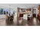 Lovely kitchen with wooden cabinets, stainless appliances, island with seating, and hardwood floors at 5322 Devils Head Cir, Golden, CO 80403
