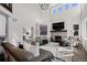 Spacious living room with tall ceilings, stone fireplace, and stylish furniture with access to an office at 5322 Devils Head Cir, Golden, CO 80403