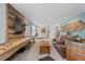 Open-concept living room with stylish decor, wooden feature walls, and comfortable seating at 5322 Devils Head Cir, Golden, CO 80403