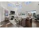 Bright, spacious living room with soaring ceilings, stone fireplace, and large windows with natural light at 5322 Devils Head Cir, Golden, CO 80403