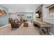 Spacious living room with comfortable leather seating, media center and game table at 5322 Devils Head Cir, Golden, CO 80403