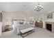 Spacious main bedroom featuring a fireplace, chandelier, sitting area and an archway to the bathroom at 5322 Devils Head Cir, Golden, CO 80403