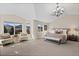 Sun-filled main bedroom with mountain views, vaulted ceilings, seating area, and a cozy fireplace at 5322 Devils Head Cir, Golden, CO 80403