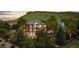 Beautifully landscaped home with large windows, back deck, and mature trees at 5322 Devils Head Cir, Golden, CO 80403