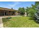 Lush backyard with mature trees, well-maintained lawn and covered patio at 380 E 111Th Pl, Northglenn, CO 80233