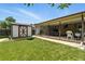 Spacious backyard features a covered patio, storage shed, and well-maintained lawn at 380 E 111Th Pl, Northglenn, CO 80233