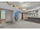 Open basement space with a coca-cola pendant light and colorful tile accent wall at 380 E 111Th Pl, Northglenn, CO 80233