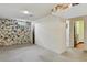 Basement featuring tile accent wall and access to additional rooms at 380 E 111Th Pl, Northglenn, CO 80233
