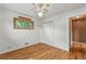 A cozy bedroom with hardwood floors includes a ceiling fan and a closet for storage at 380 E 111Th Pl, Northglenn, CO 80233