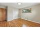 A bedroom with wood floors features a closet, window, and a light and bright ambiance at 380 E 111Th Pl, Northglenn, CO 80233