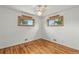 A charming bedroom featuring hardwood floors, abundant natural light, and a ceiling fan at 380 E 111Th Pl, Northglenn, CO 80233