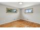 A bedroom with hardwood floors, natural light, and neutral walls offers a cozy retreat at 380 E 111Th Pl, Northglenn, CO 80233