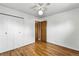 A bedroom with hardwood floors includes a closet and an adjacent hallway entrance at 380 E 111Th Pl, Northglenn, CO 80233