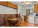 Cozy eat-in kitchen featuring wood cabinets and a glass table set for four at 380 E 111Th Pl, Northglenn, CO 80233