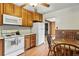 Kitchen with appliances, a breakfast nook, and wood-look flooring at 380 E 111Th Pl, Northglenn, CO 80233