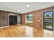 Bright living room with hardwood floors, a large window, and a view of the front yard at 380 E 111Th Pl, Northglenn, CO 80233