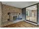 Cozy brick fireplace and wood paneling in living room at 380 E 111Th Pl, Northglenn, CO 80233