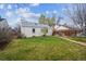 Beautiful backyard with lush green grass, stone pathway and plenty of space at 1220 Magnolia St, Denver, CO 80220