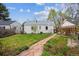 Well-maintained backyard with green grass and a charming stone pathway at 1220 Magnolia St, Denver, CO 80220