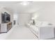 Finished basement with neutral colors, plush carpeting, and comfortable seating at 1220 Magnolia St, Denver, CO 80220