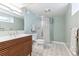 Stylish bathroom featuring a modern vanity, shower, and patterned tile floors at 1220 Magnolia St, Denver, CO 80220