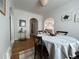 Bright dining room with a round table, hardwood floors, and arched doorways at 1220 Magnolia St, Denver, CO 80220