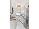 Bright kitchen features white cabinets, stainless steel appliances, and butcher block countertops at 1220 Magnolia St, Denver, CO 80220