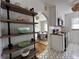 Open kitchen view with floating shelves, updated appliances, and an open dining area at 1220 Magnolia St, Denver, CO 80220