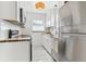 Bright, clean kitchen featuring stainless steel appliances, white cabinetry, and tiled flooring at 1220 Magnolia St, Denver, CO 80220